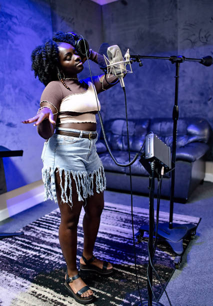 Independent vocalist performing at a studio microphone